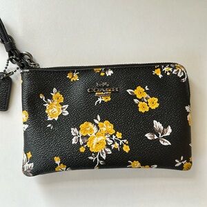Coach wristlet. Black white and yellow floral print. Adorable!